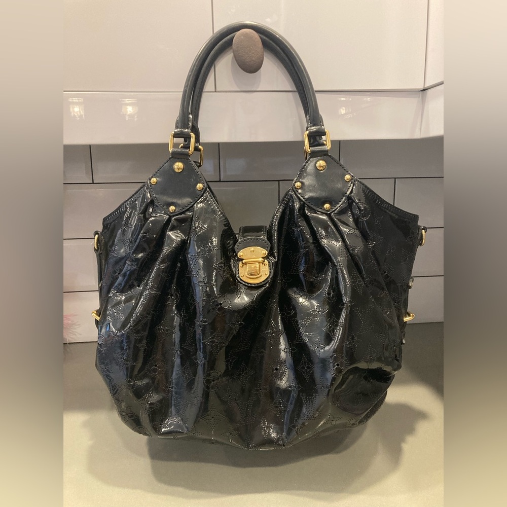 Louis Vuitton. Authentic Louis Vuitton Surya Mahina hobo bag.